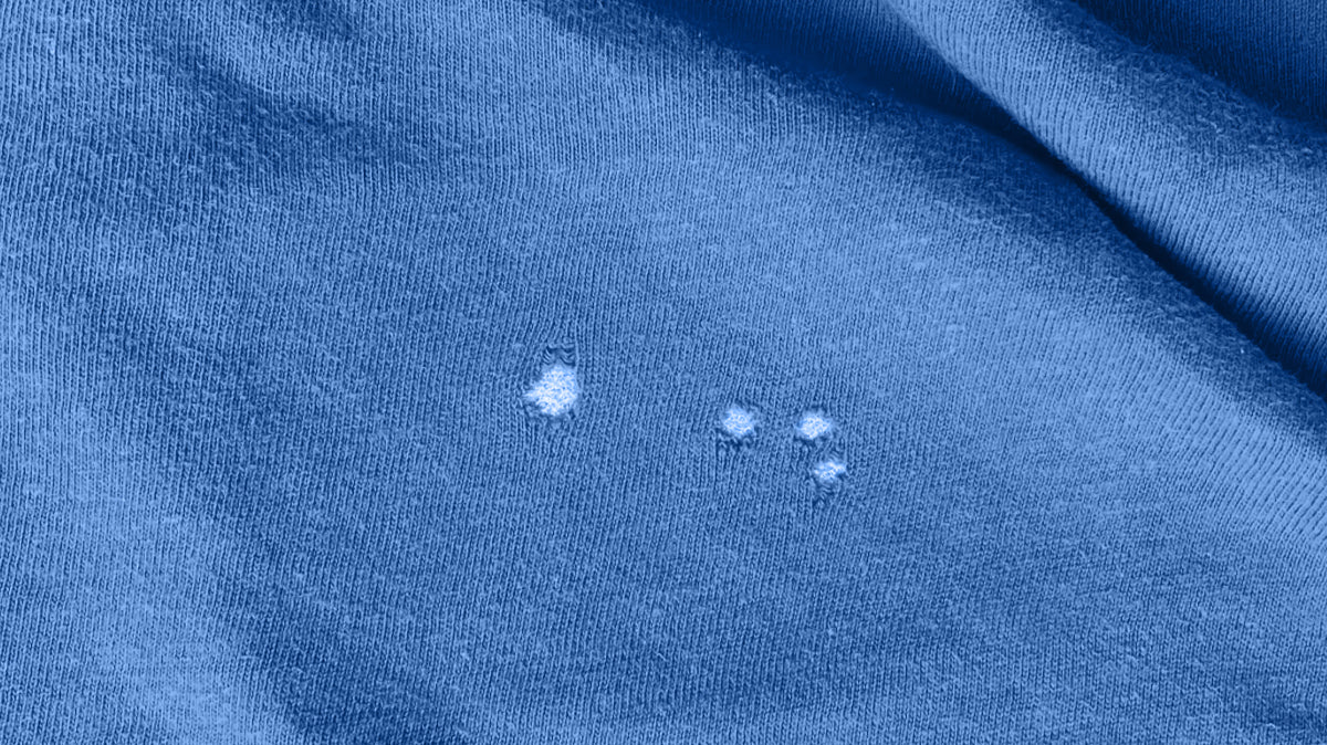 What Causes the Little Holes in My T-shirt?