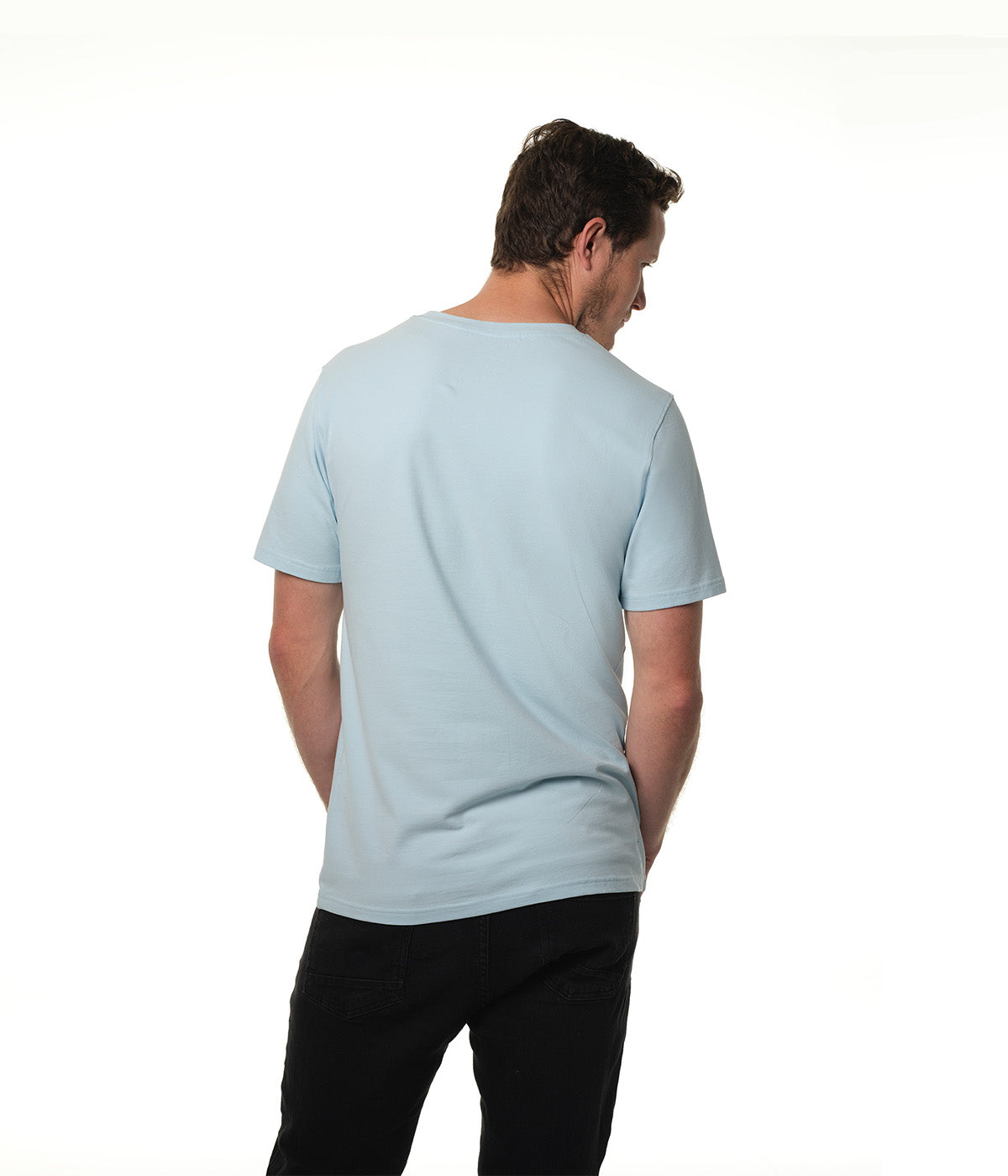 Male model facing away from camera wearing our "breakwater" light blue t-shirt.