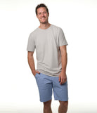 Male model smiling wearing pale blue shorts with our "ash" gray premium t-shirt